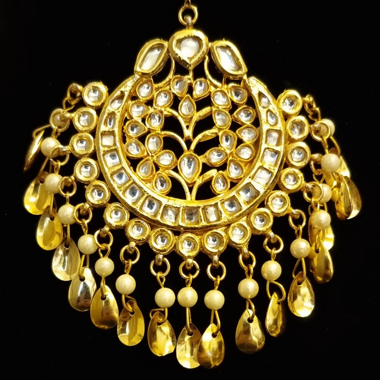 Kundan with golden pipal patti  earrings and tikka.