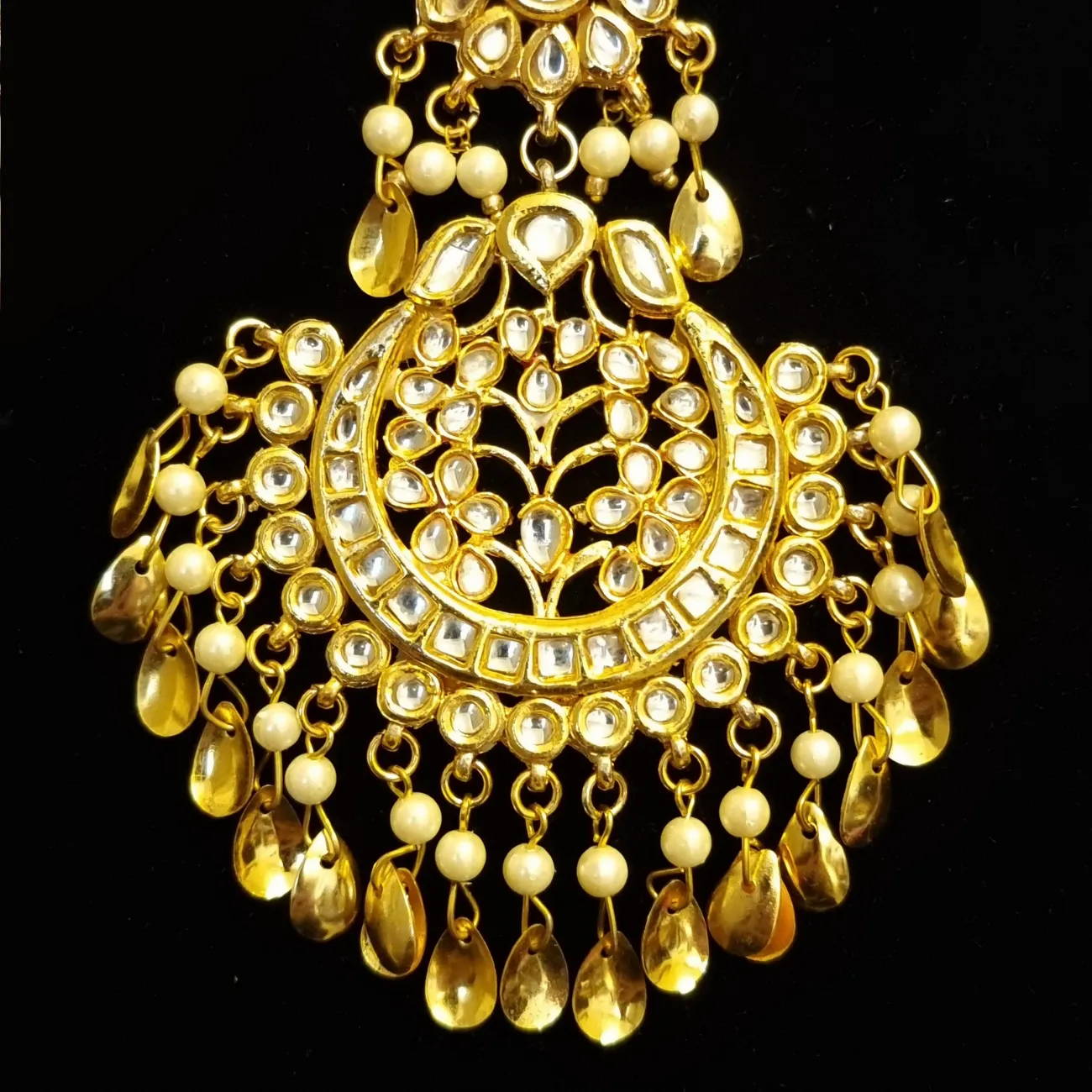 Kundan with golden pipal patti  earrings and tikka.